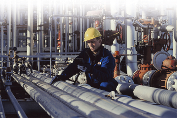 Photo of field technician performing maintenance on a pipeline